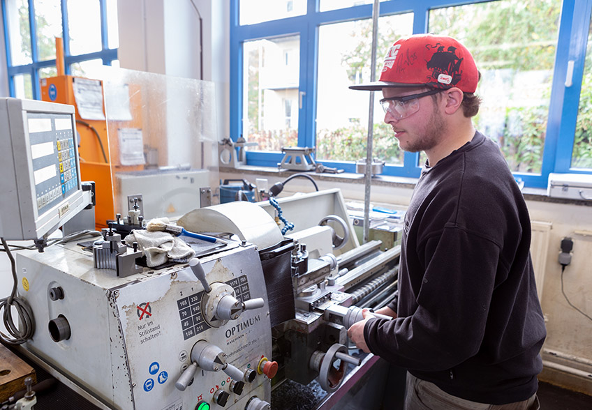 Auszubildender mit Schutzbrille bei der Arbeit